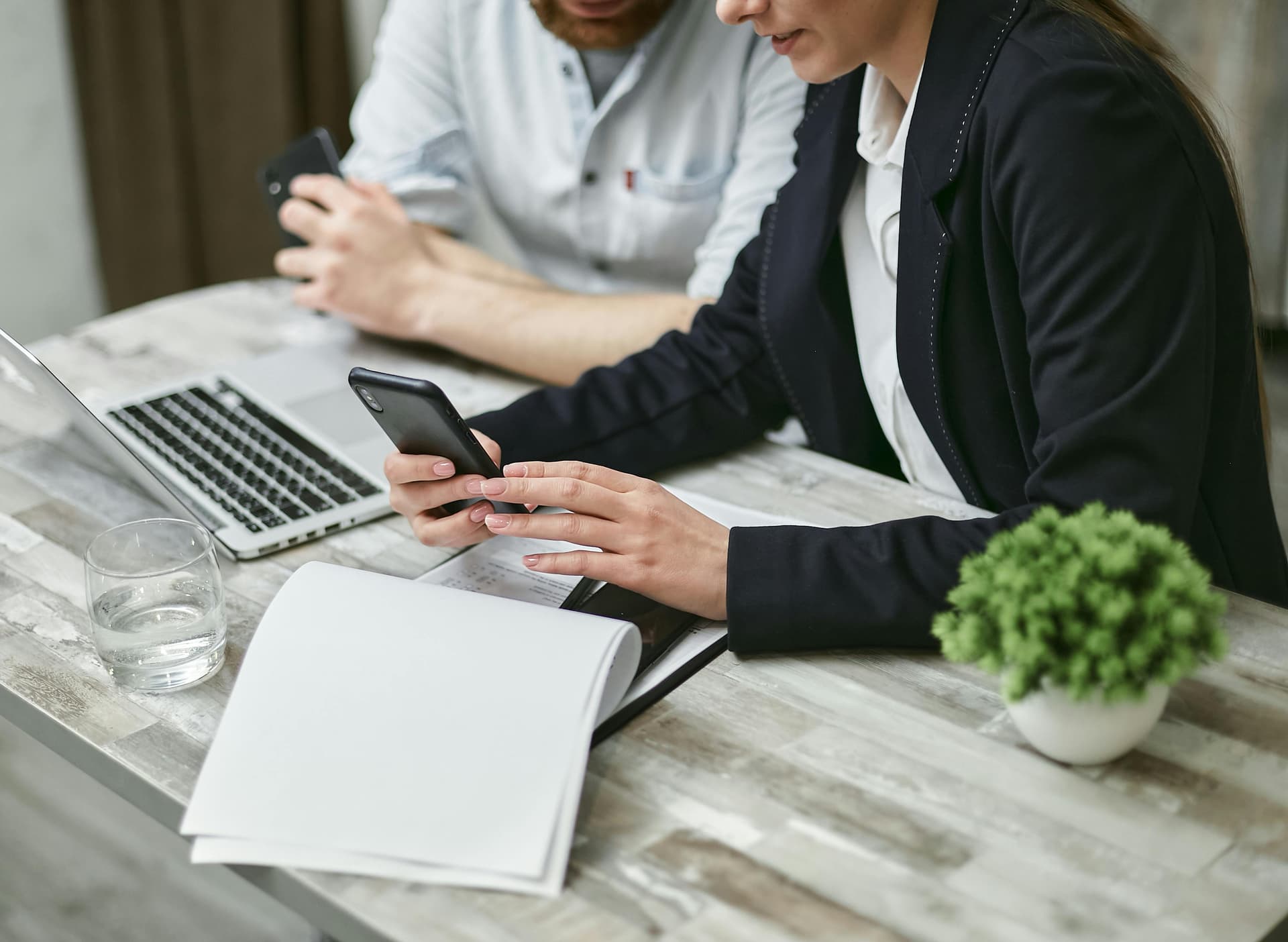 Two people looking at a phone screen