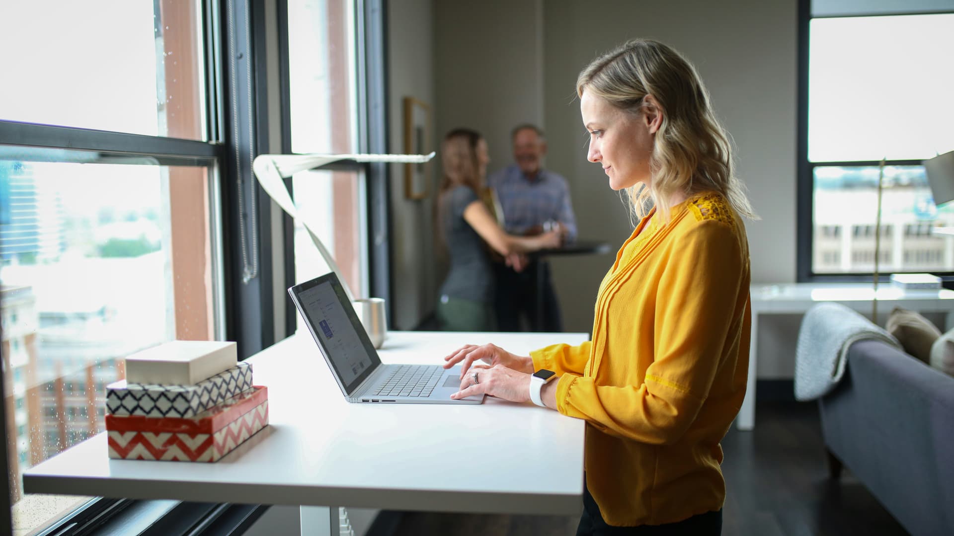Woman working at laptop at standing desk
