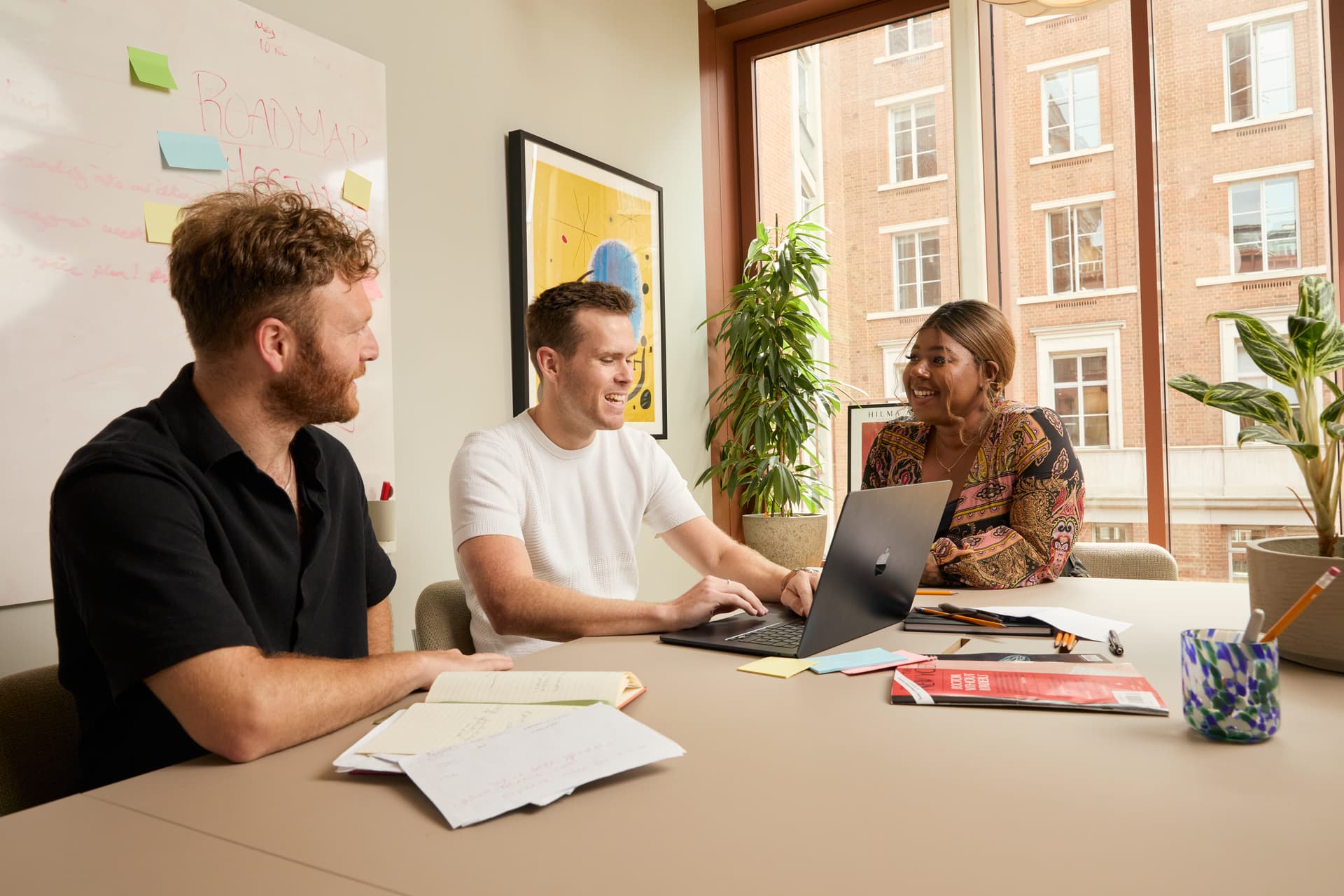 Three people in a meeting room