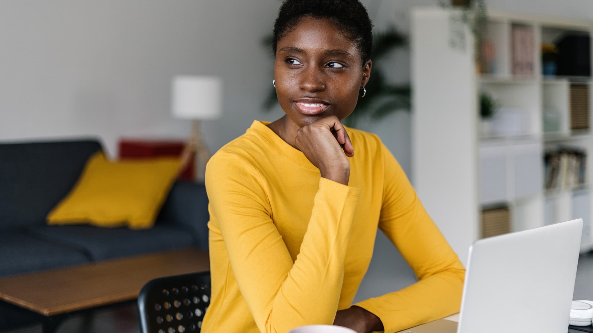 Woman at laptop, changing email signature in Outlook