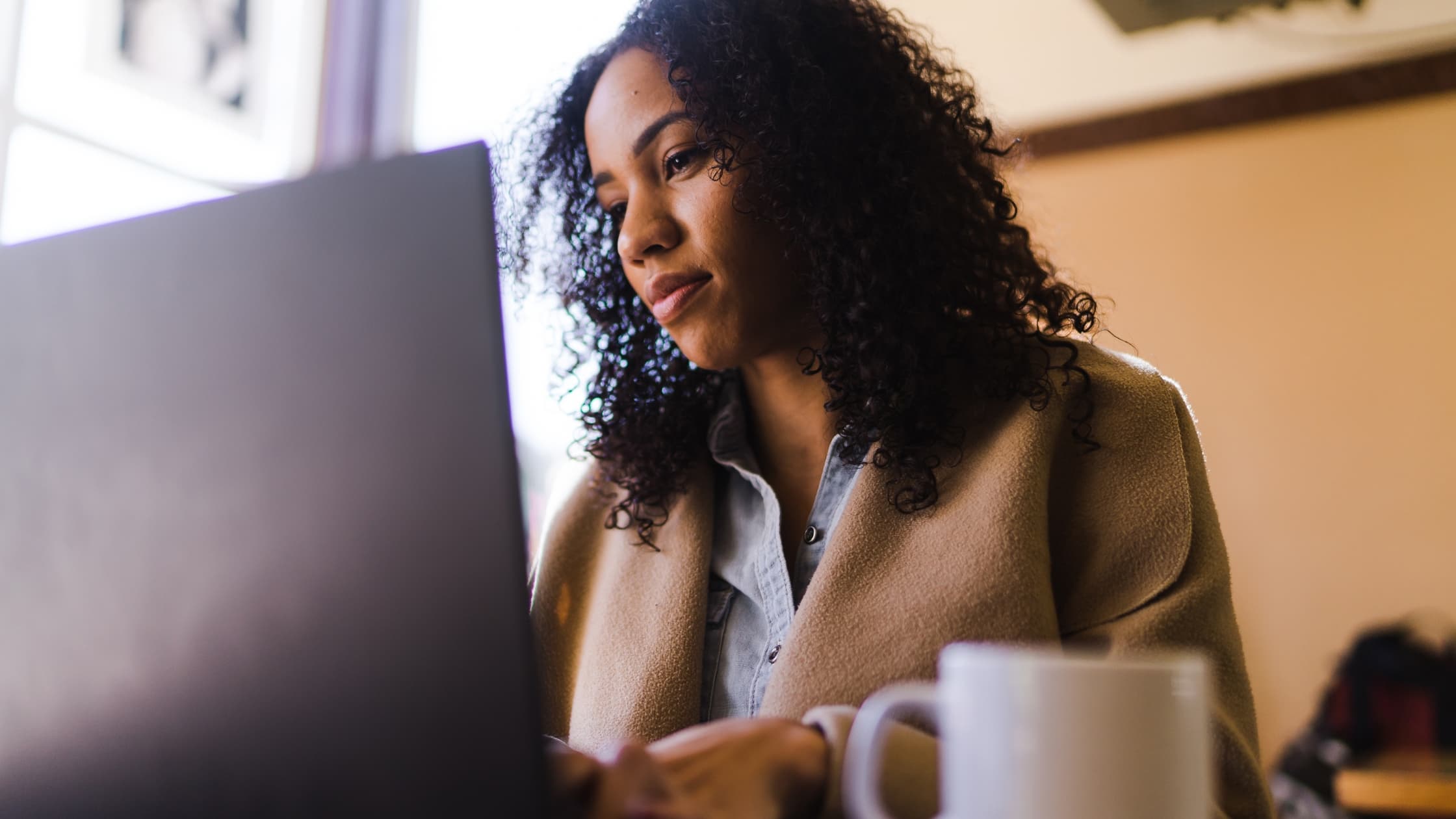 Woman at laptop searching for archived emails in Gmail