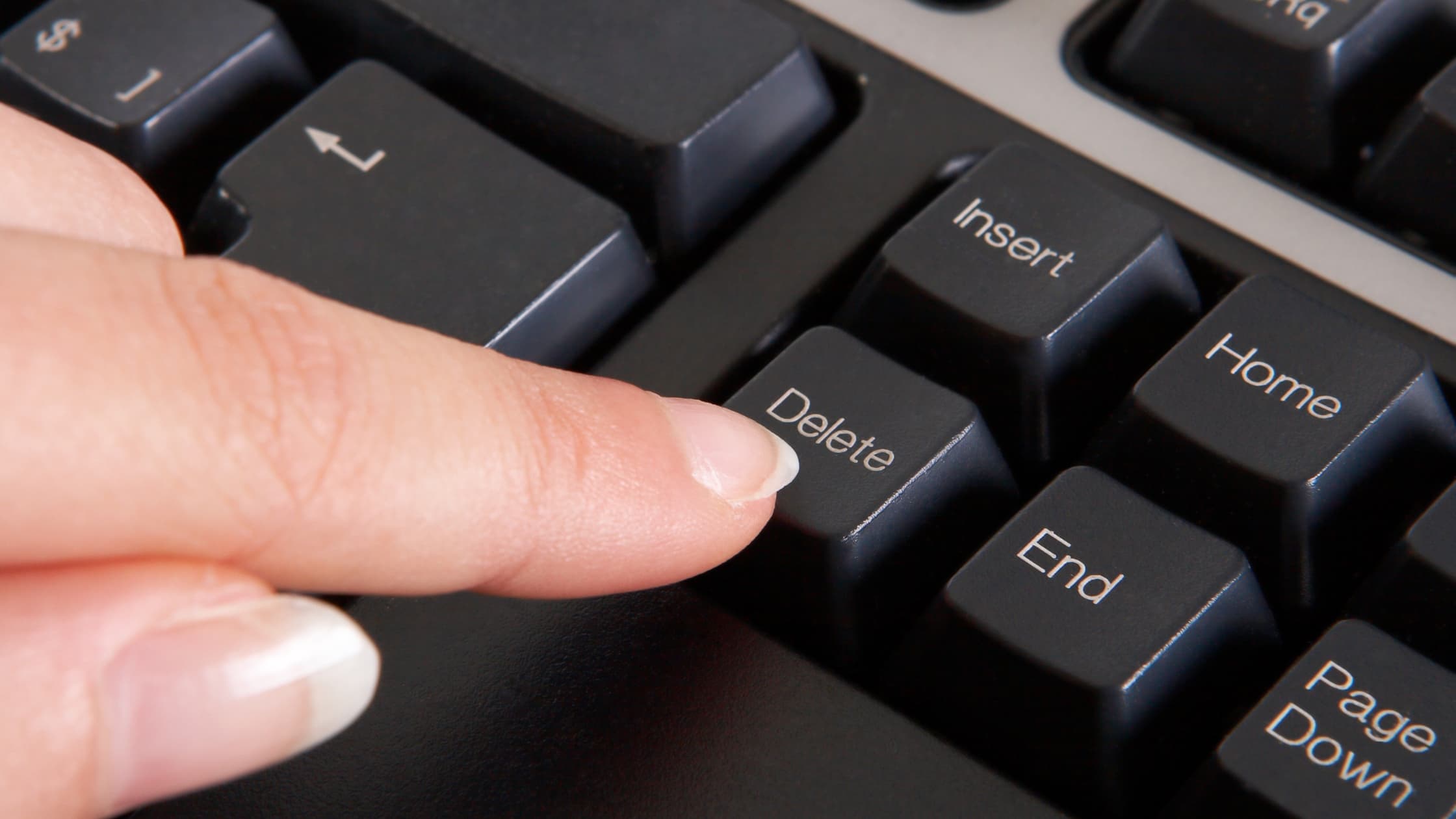 Person on laptop mass deleting emails in Gmail