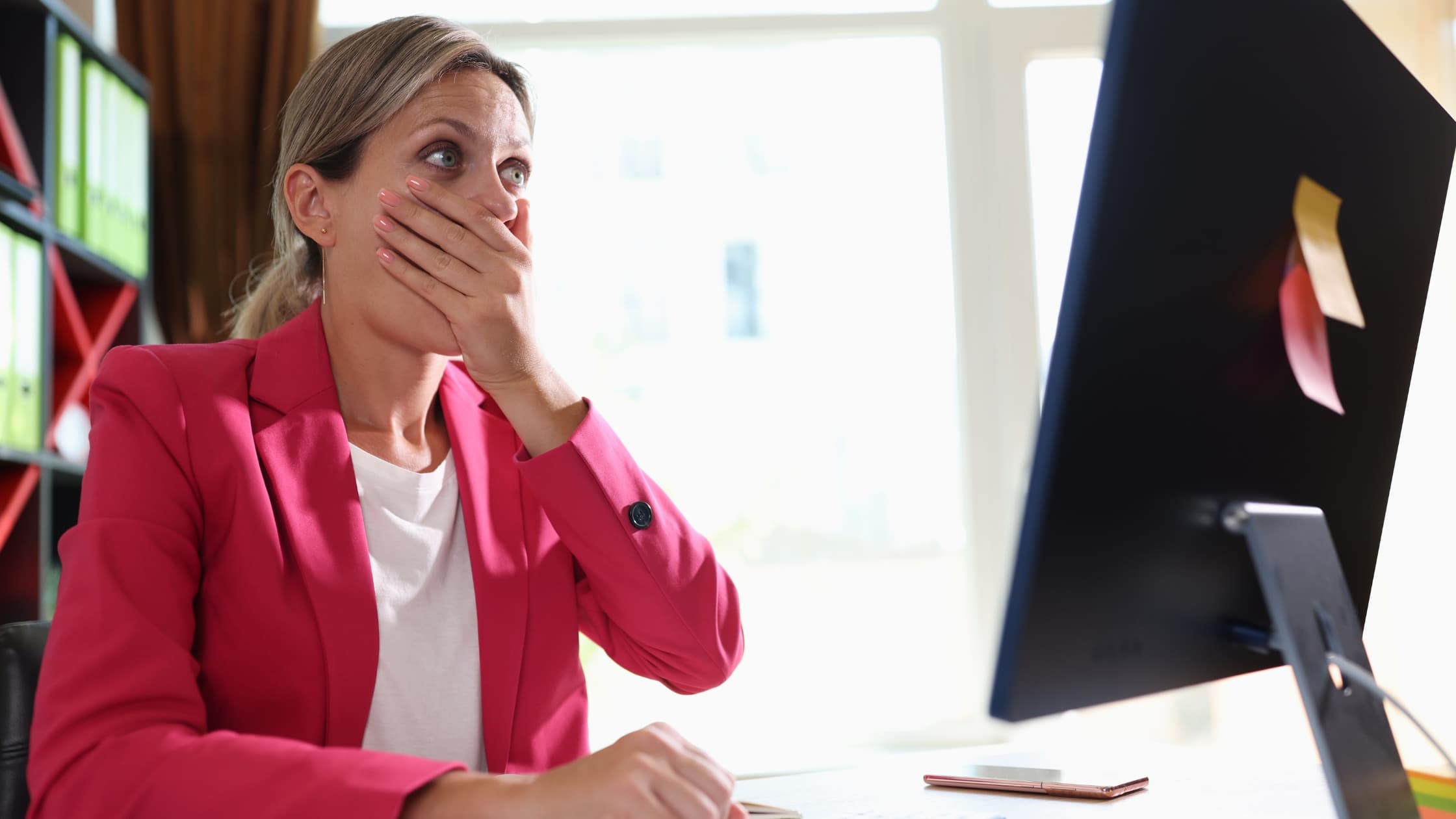 Woman shocked at laptop looking how to unsend an email in Gmail