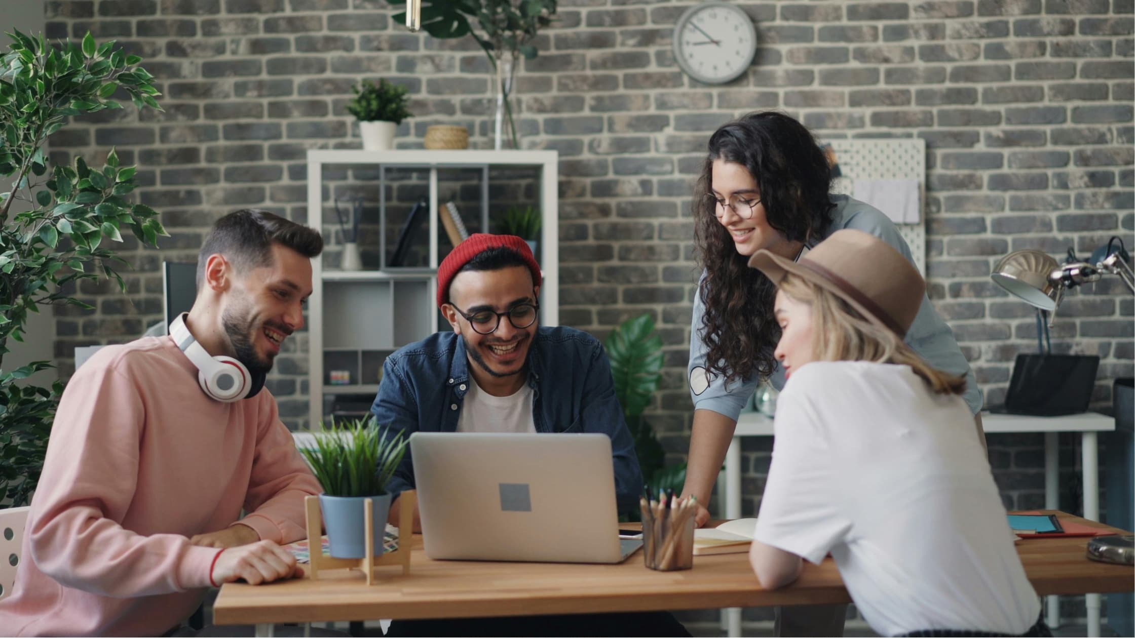 People around a computer, making an email group in Gmail