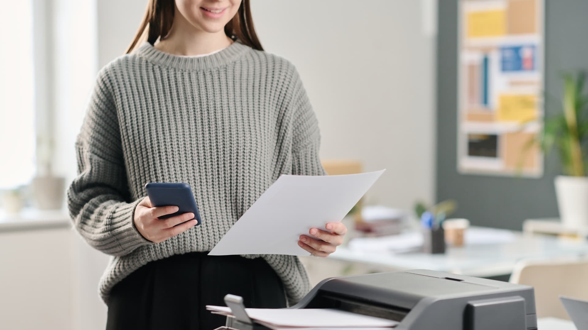 Woman at printer, printing emails