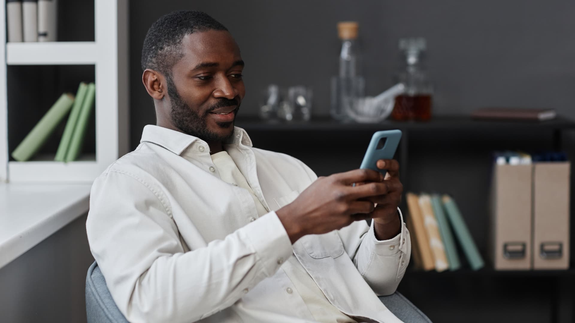 Man sending an email on his phone