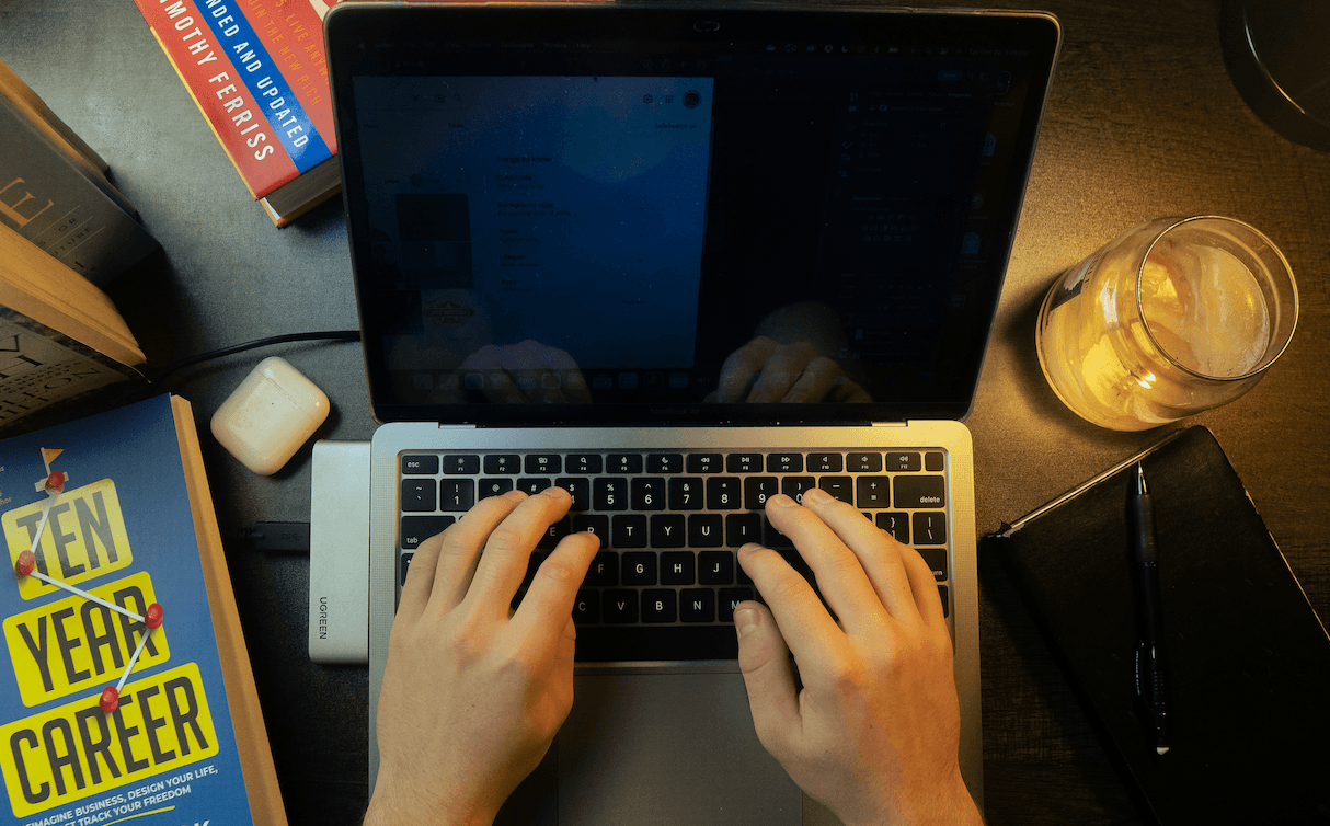 Hands typing on laptop