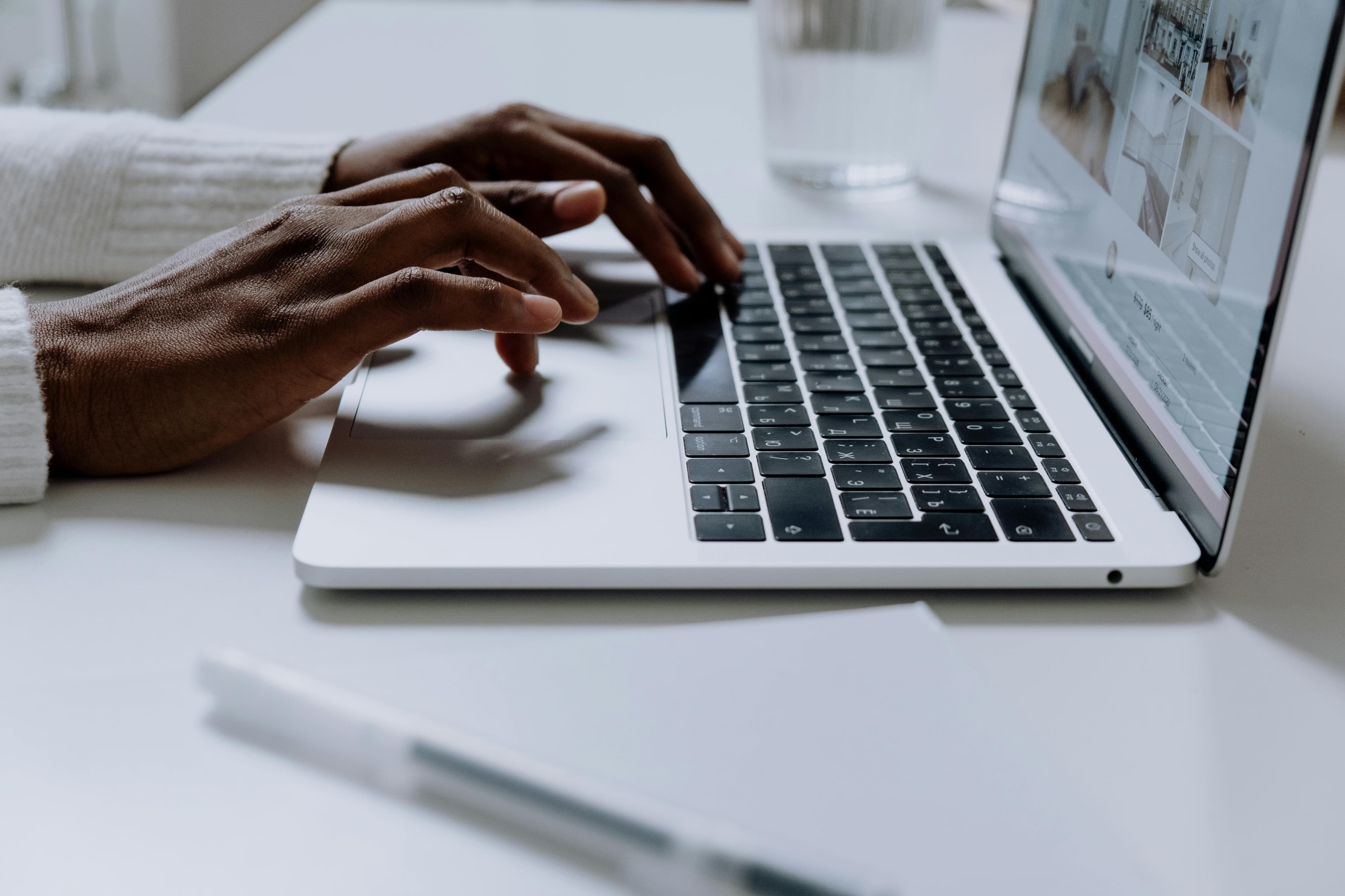 Woman typing at laptop