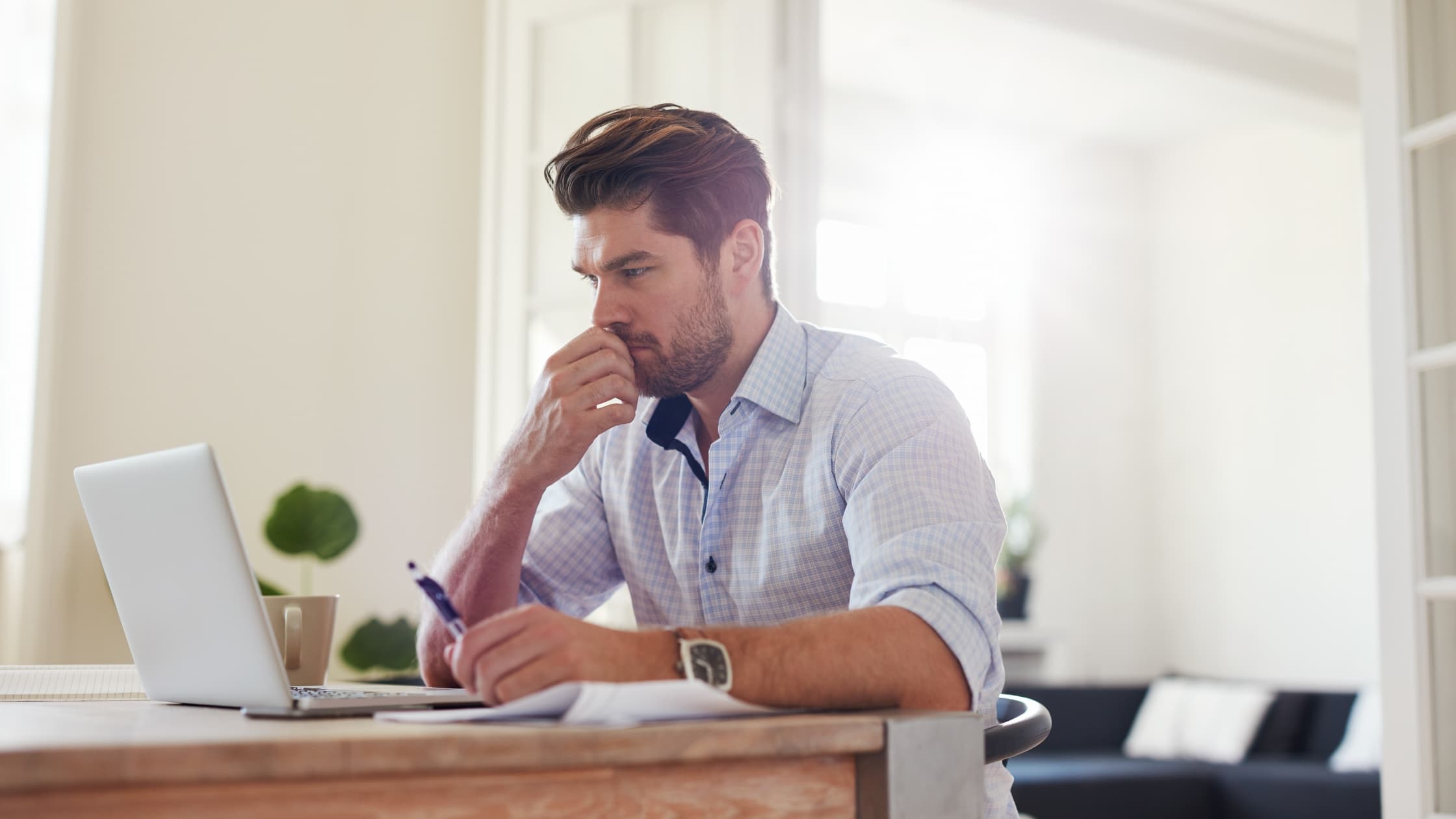 Man looking at his laptop, sending a CC and BCC email