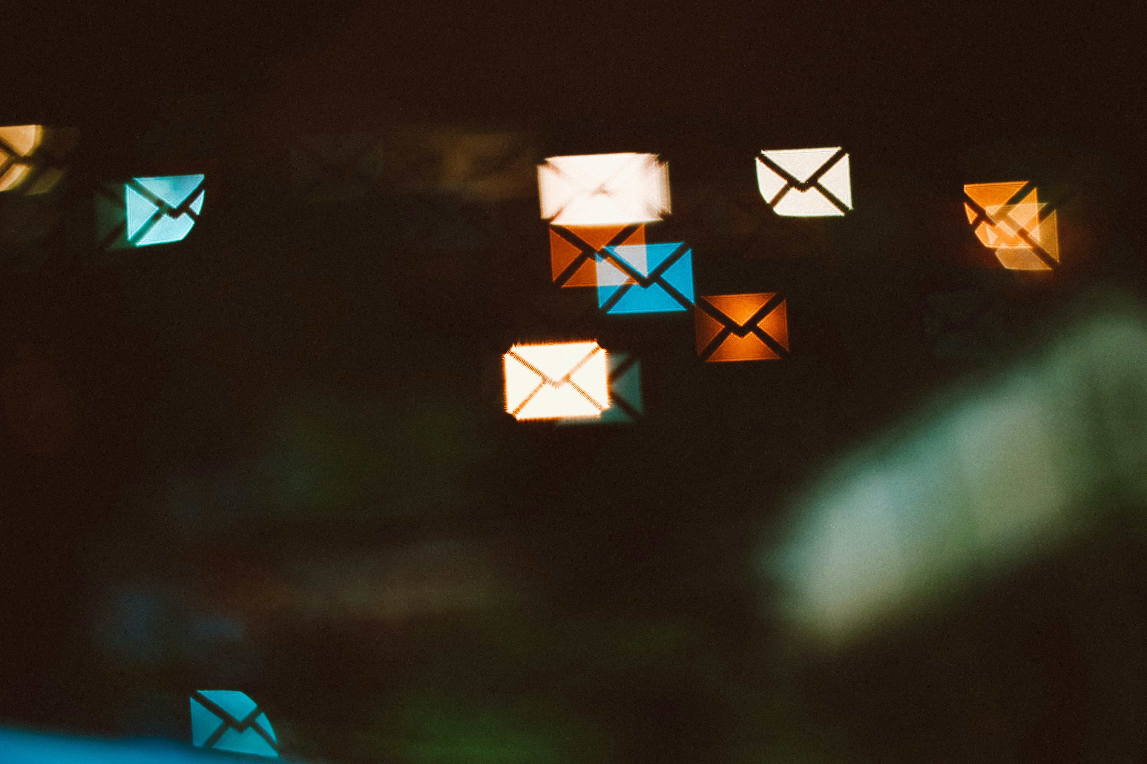 Emails floating on black background