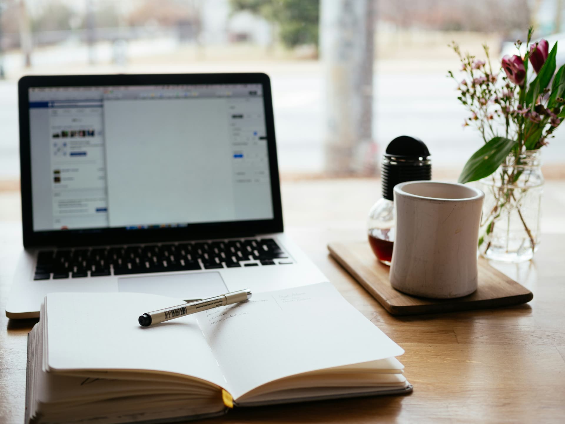 laptop and coffee mug on table