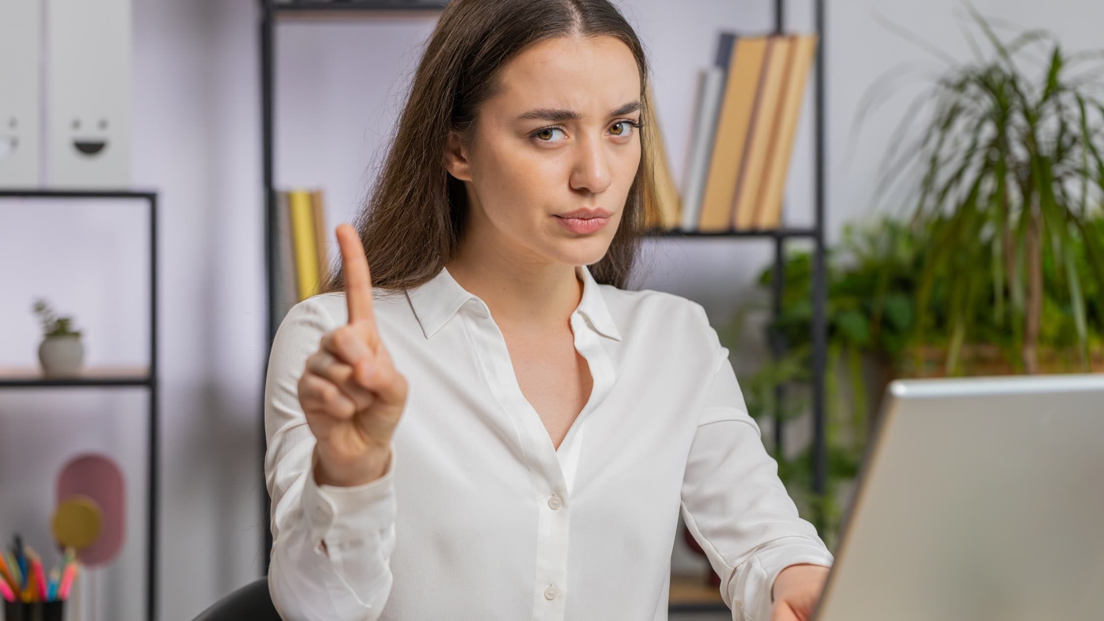 Woman wagging her finger blocking an email in Gmail