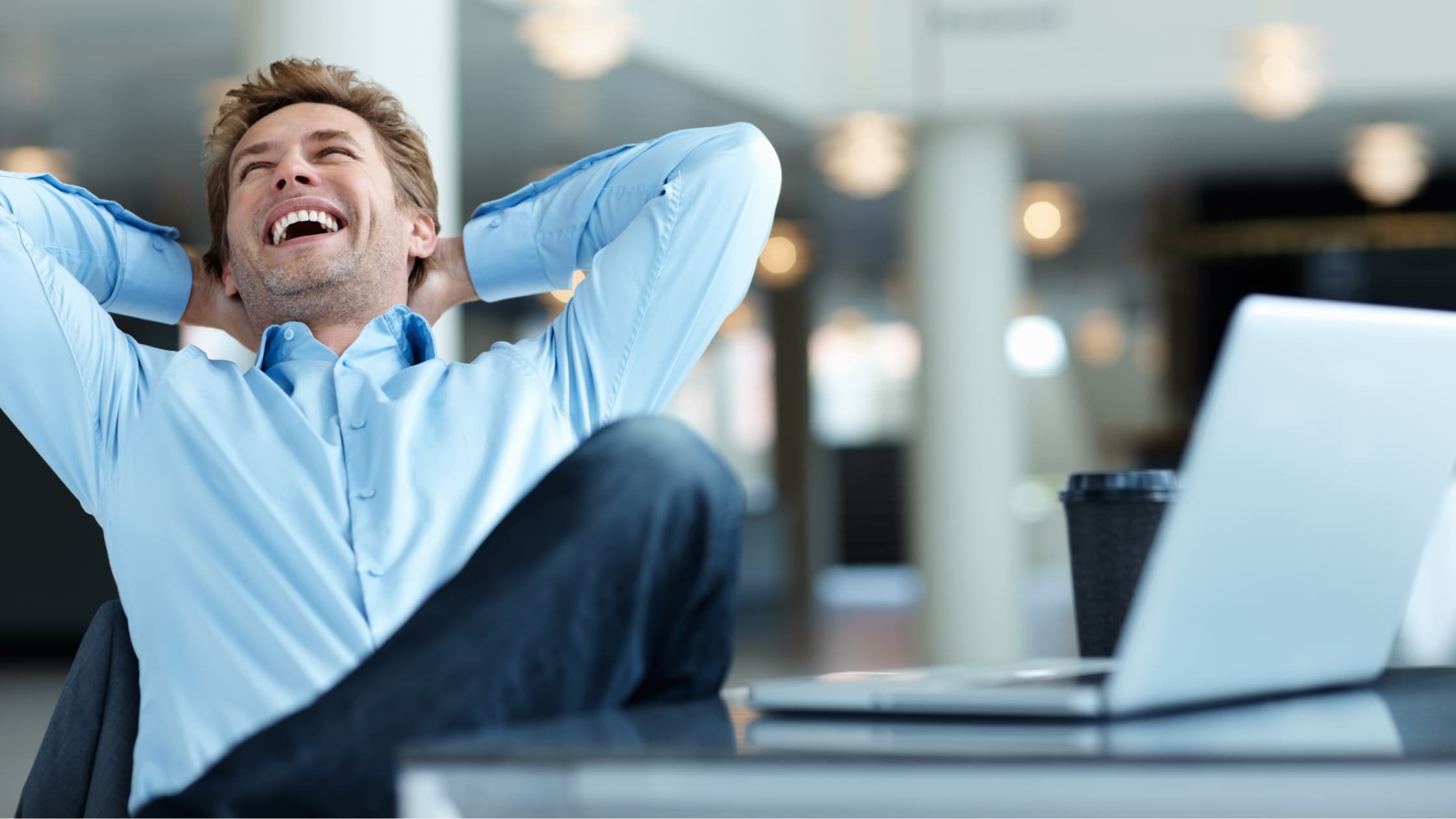 Man relaxing at his laptop, creating and saving email templates in Gmail