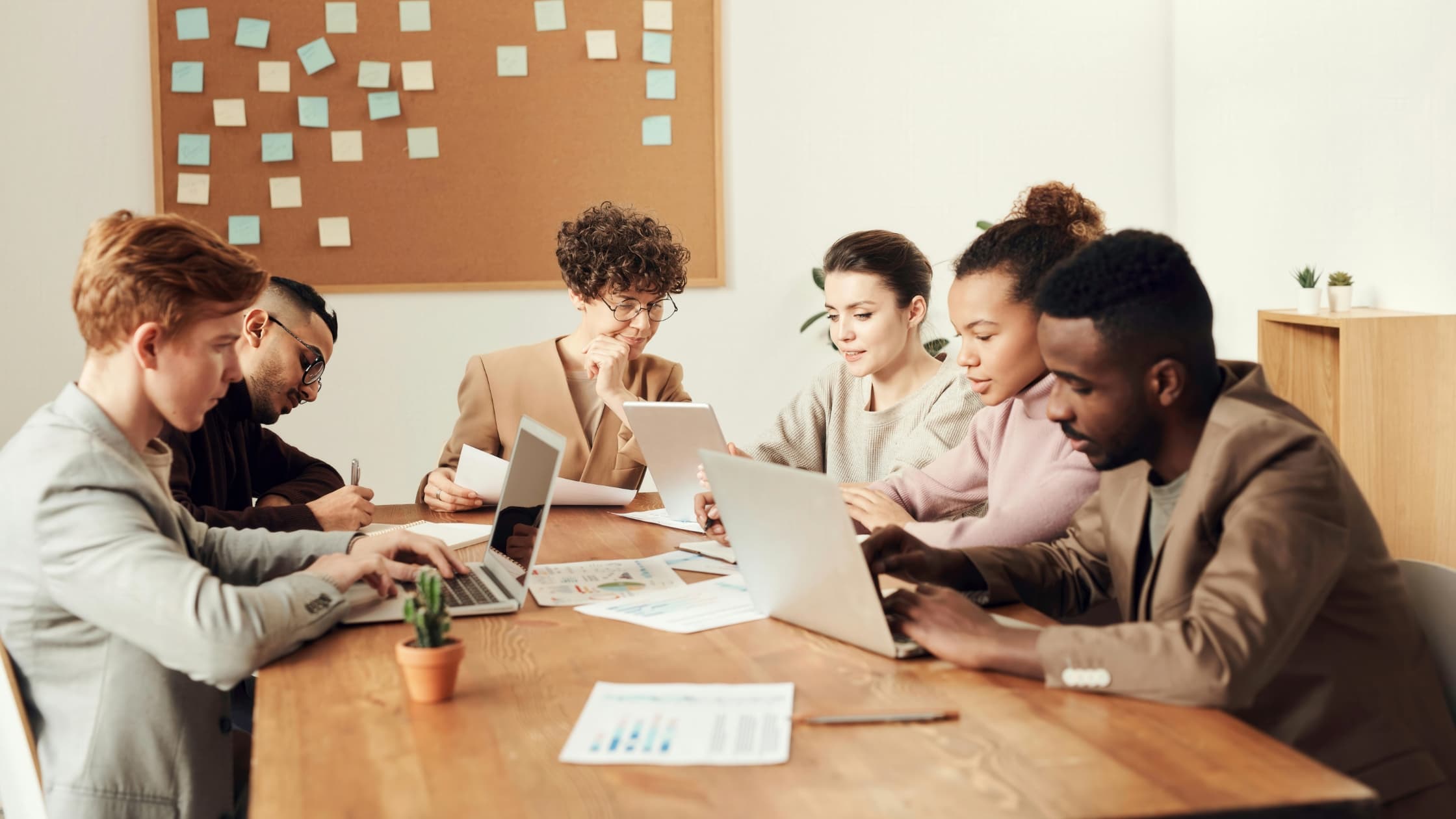 Team around laptops being productive at work