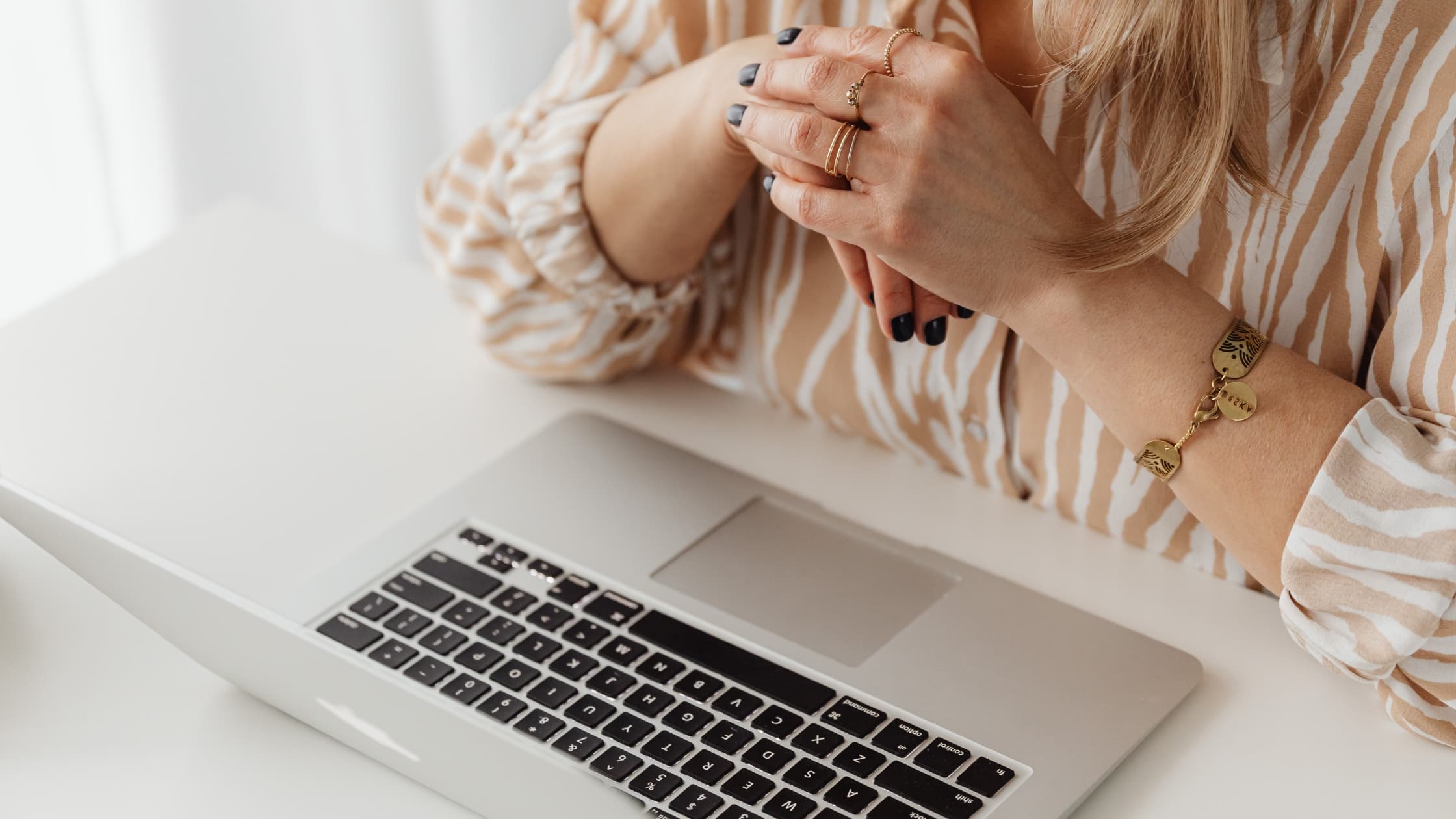 Woman at laptop trying to recover deleted emails