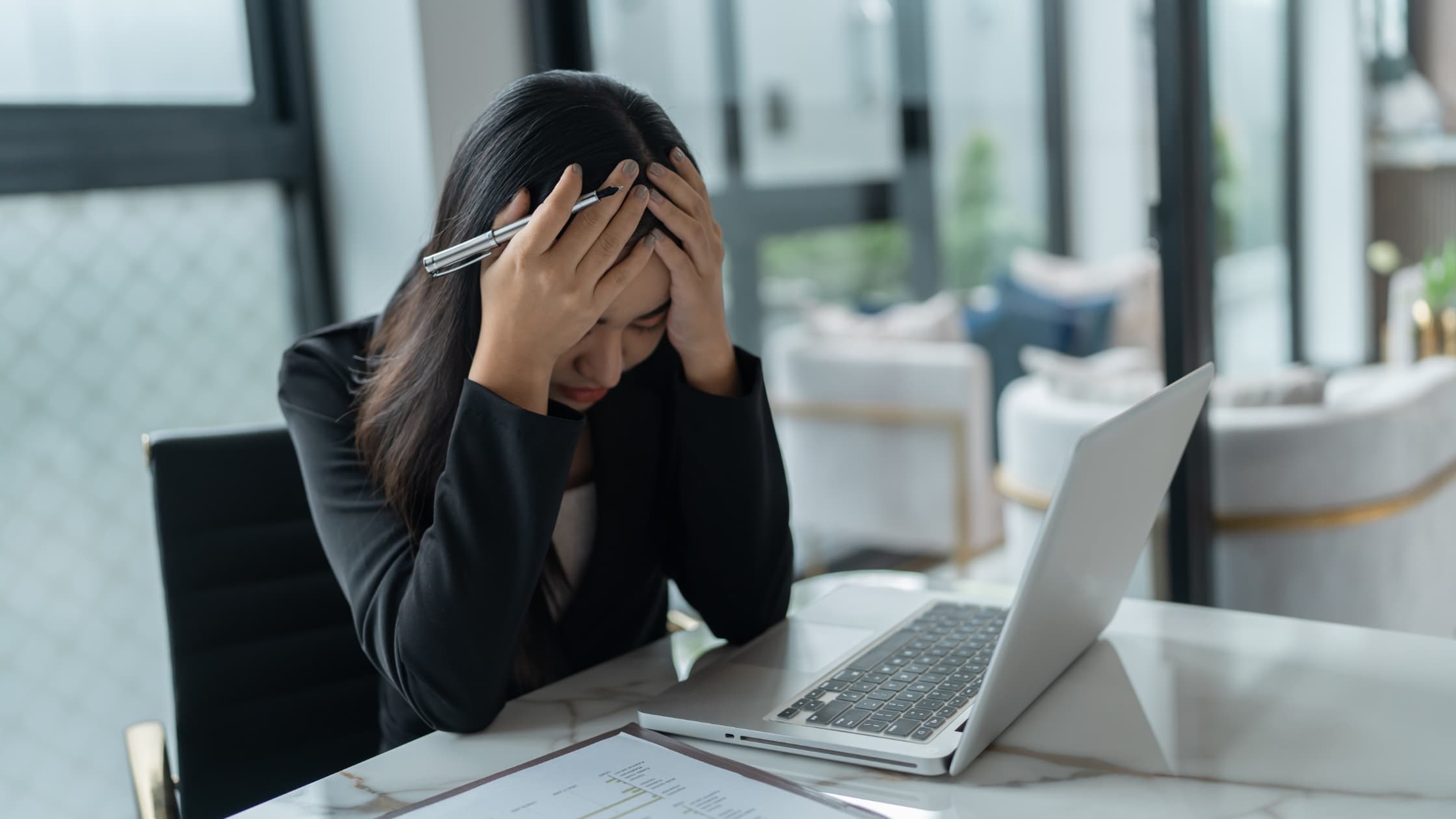 Woman at laptop experiencing meeting anxiety