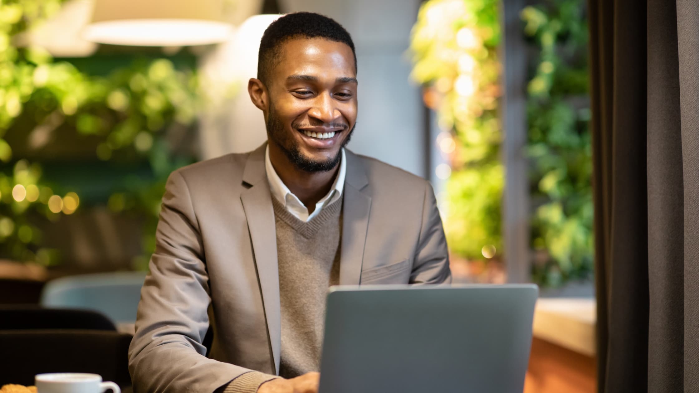 Man at laptop, sending an email to customer service