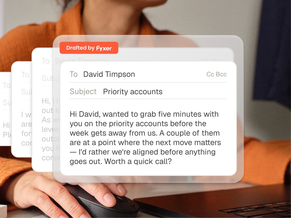 A person types on a laptop with an email draft on screen addressed to David Timpson about discussing priority accounts and scheduling a quick call.